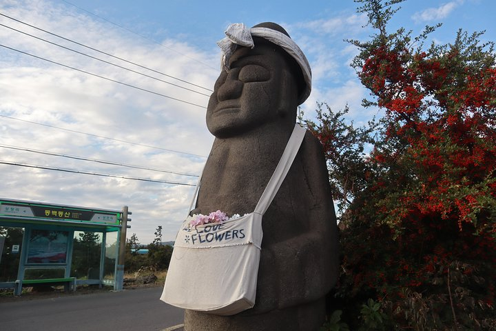 Explore Jeju Island's unique charm with its iconic stone statues and lush surroundings perfect for creating memories as you discover the island's hidden treasures at your own pace.